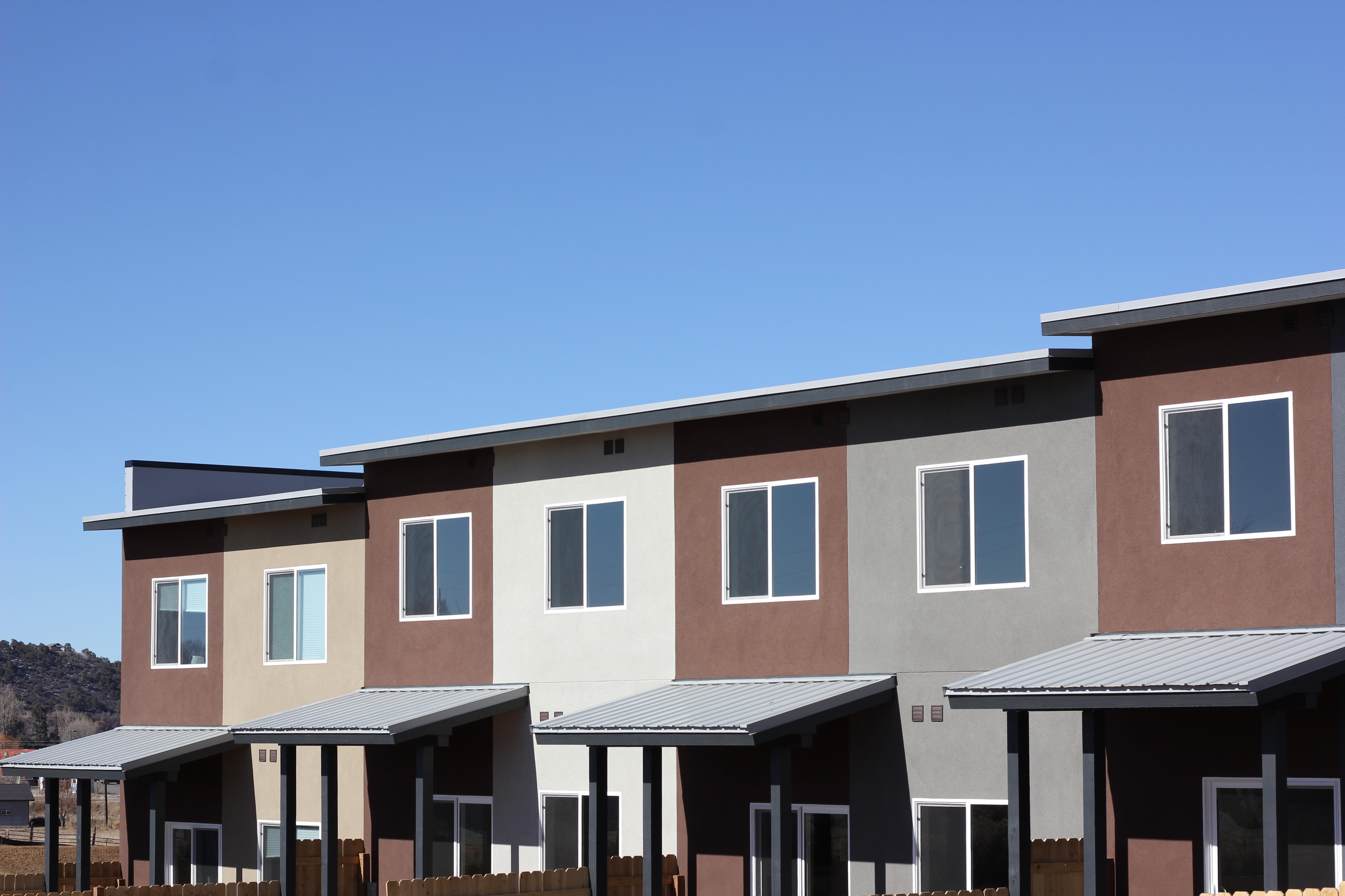 Exterior of townhomes with blue sky