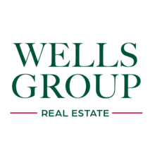 Logo with green text that reads Wells Group real estate 